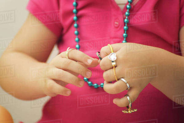 Little girl putting on plastic rings, cropped view - Royalty-free Stock ...