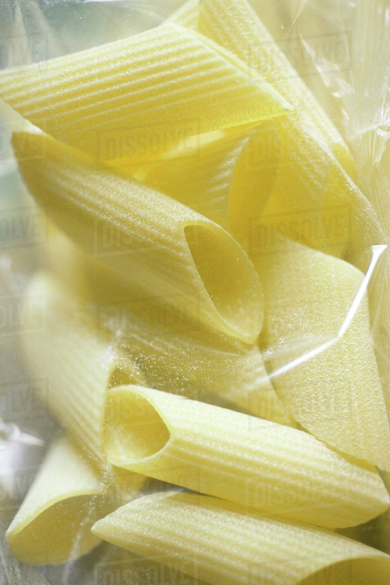 Penne pasta in package, closeup Stock Photo Dissolve