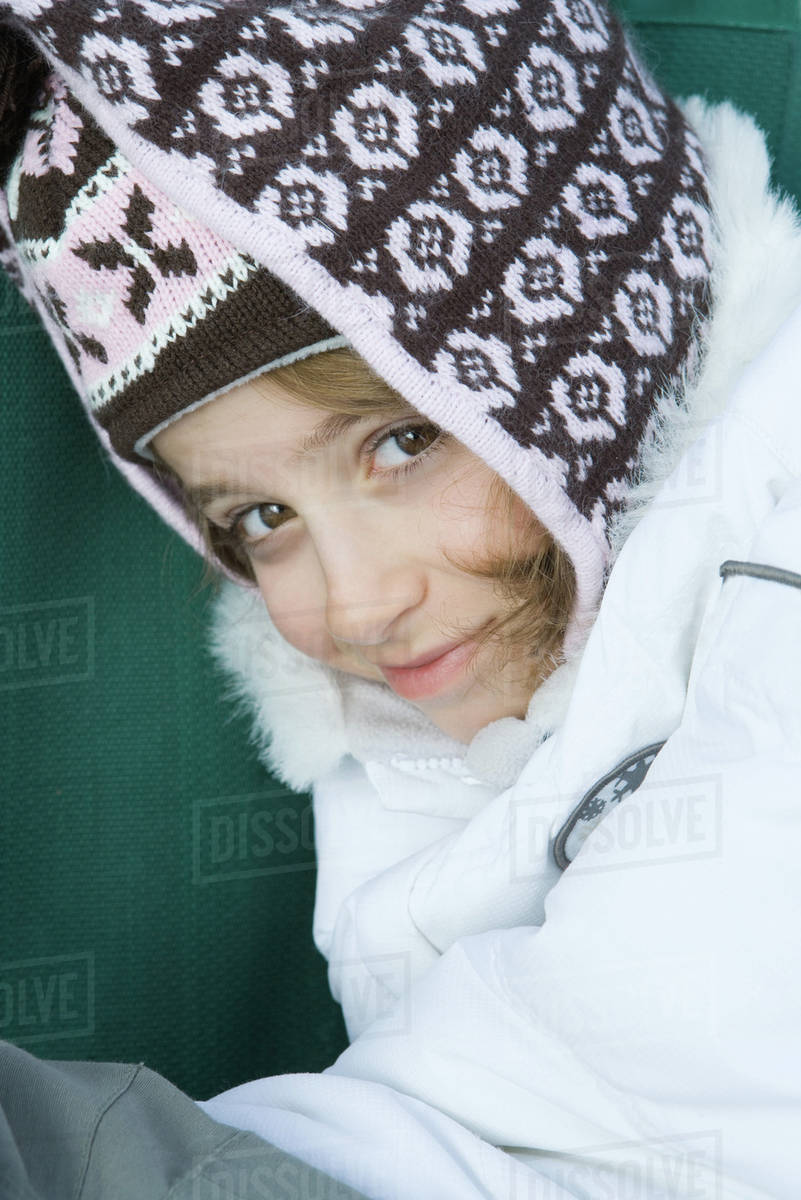 Girl wearing winter clothes, smiling at camera, portrait Stock Photo