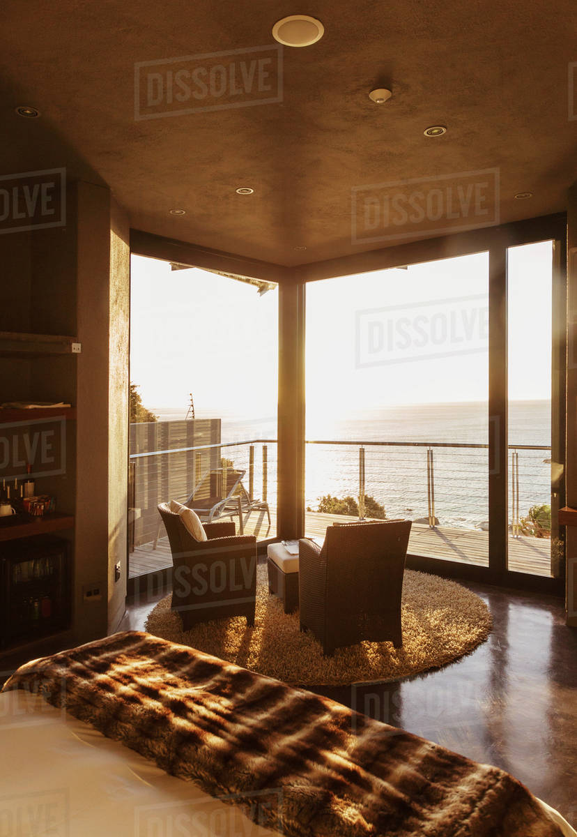 Luxury bedroom overlooking ocean at sunset Stock Photo Dissolve