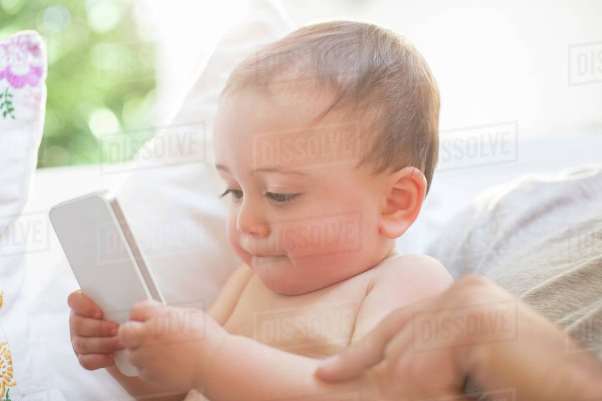 Baby boy playing with cell phone Royalty-free stock photo