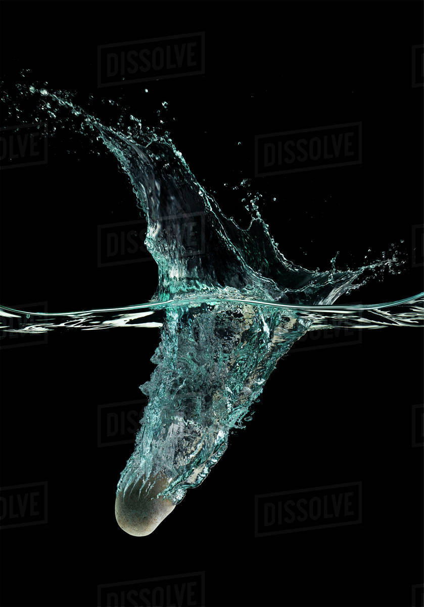 Stone dropping into water Stock Photo Dissolve