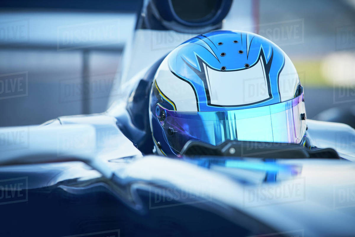 Close up formula one race car driver wearing blue helmet Royalty-free stock photo