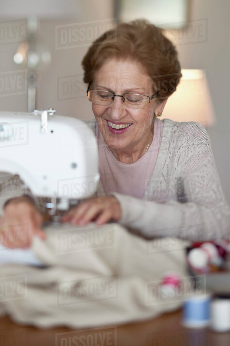 A senior woman sewing Stock Photo Dissolve