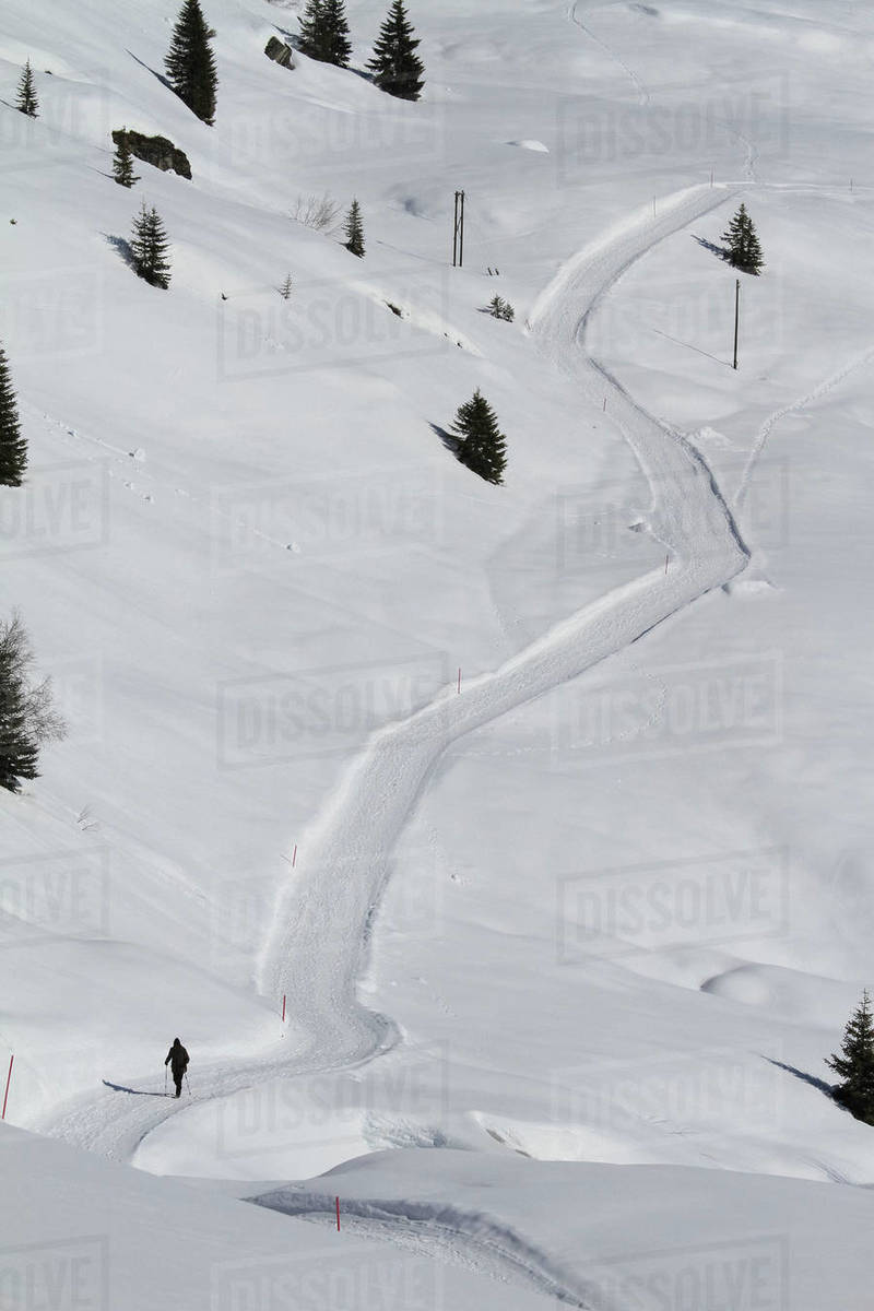 Cross country skier on snow covered mountain path, Vals, Canton of Grisons, Switzerland Royalty-free stock photo