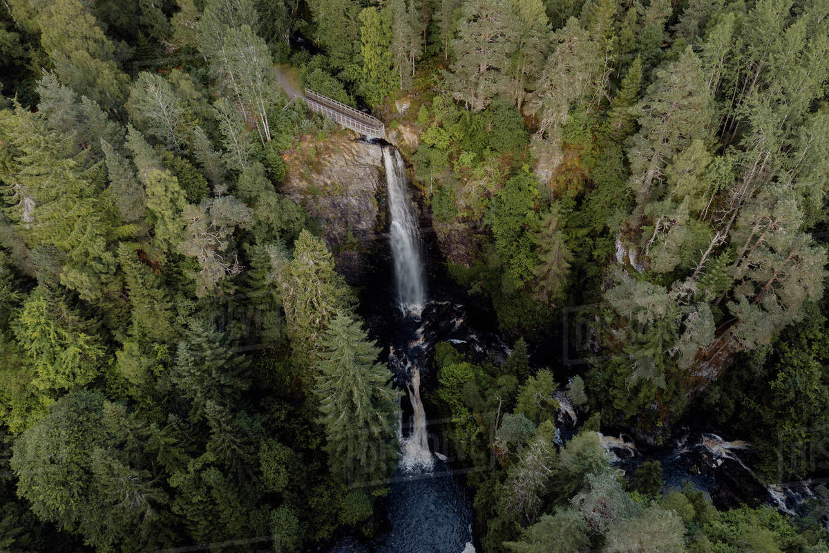 Aerial view of waterfall among forest trees, Plodda Falls, Inverness