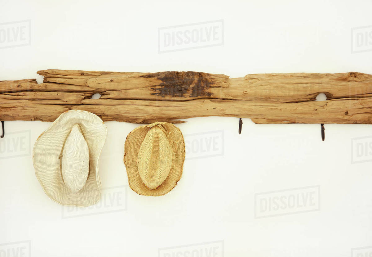 Straw Hats Hanging from Coat Rack - Royalty-free Stock Photo | Dissolve
