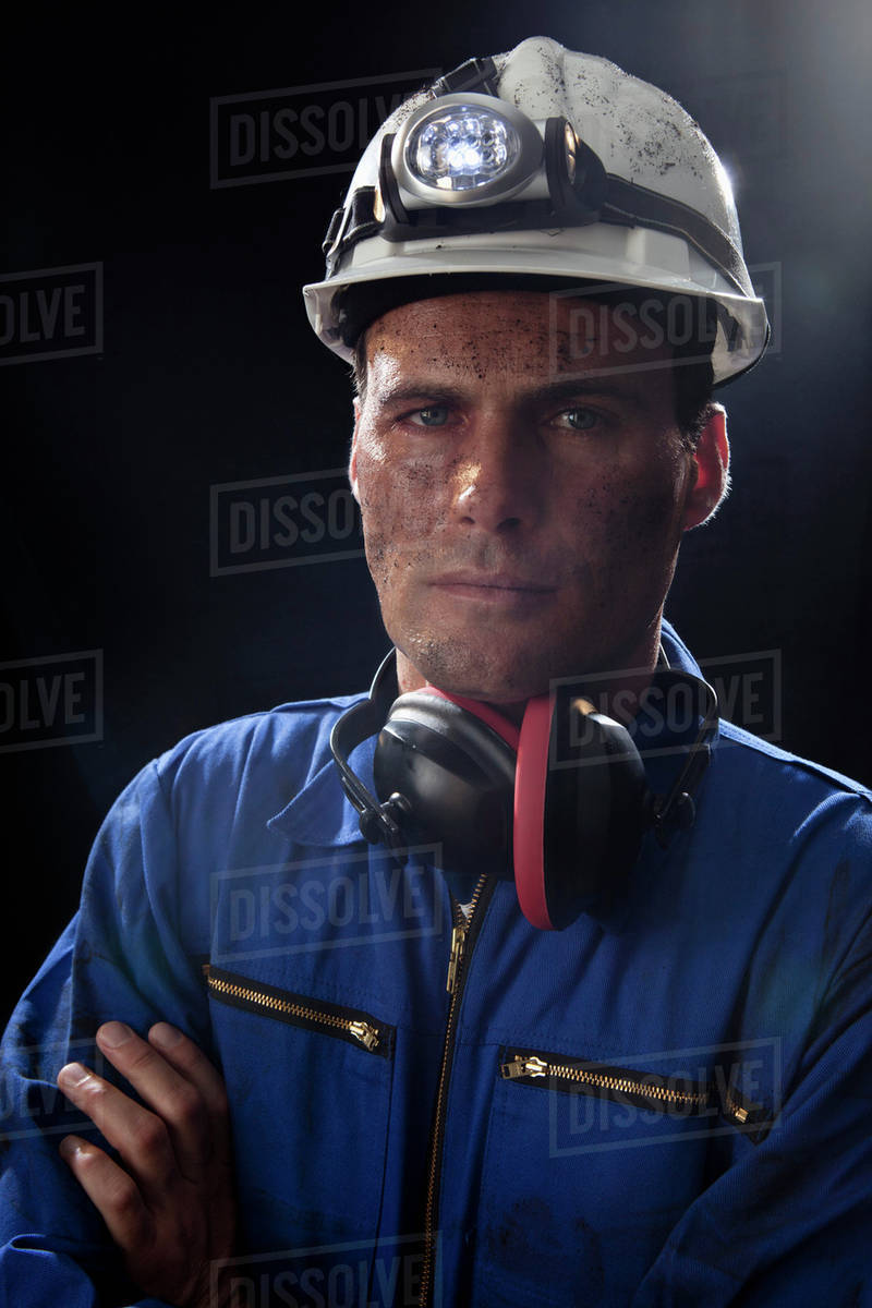 A coal miner with his arms crossed, portrait Stock Photo Dissolve