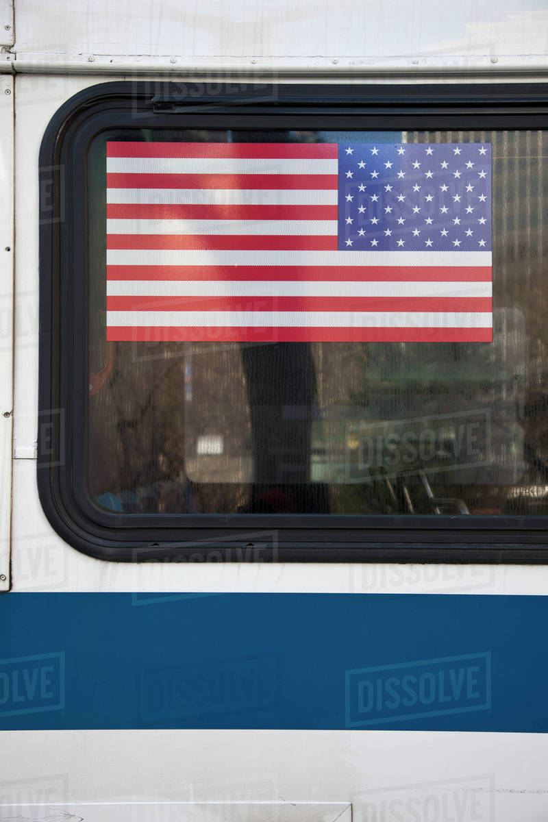 American flag on a bus window Stock Photo Dissolve