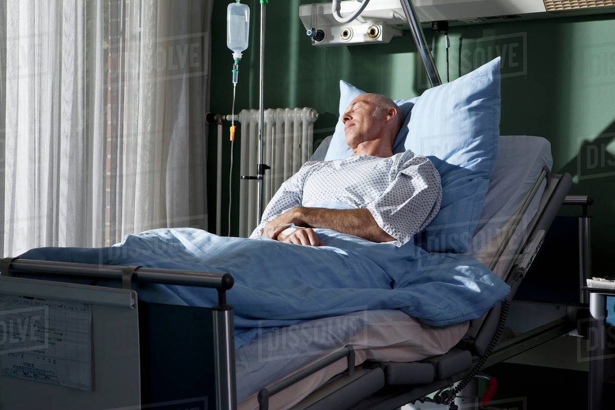 A man sleeping in a hospital bed Stock Photo Dissolve